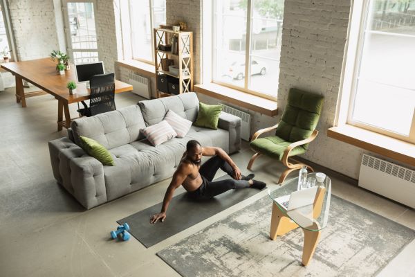 man on a training mat in his home