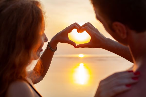 couple make a heart out of their hands 