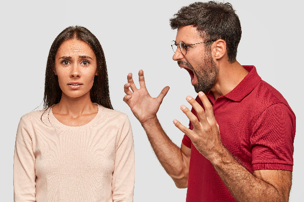 angry man shouting at a woman